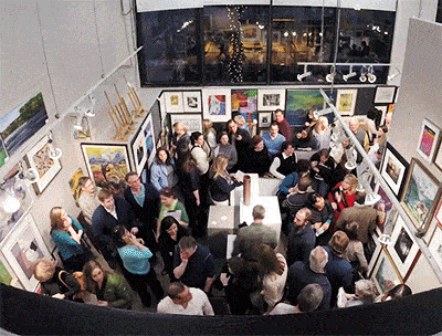 Full Art Gallery walls being stripped of art work by eager patrons.